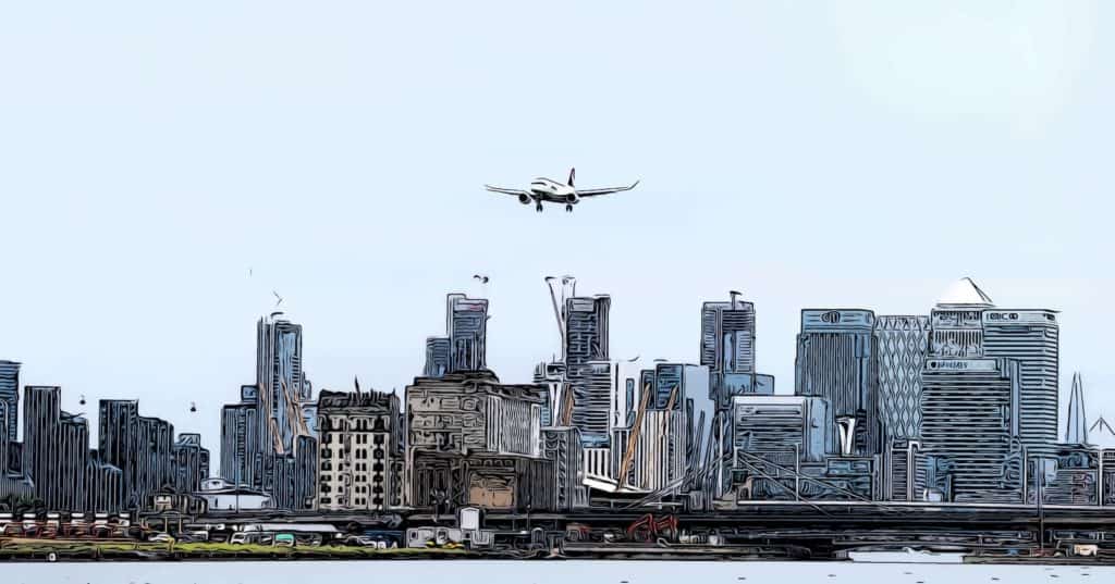 plane landing at london city airport canary wharf background
